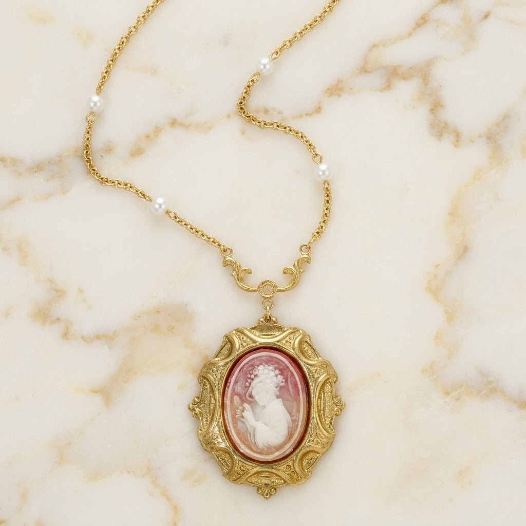 Victorian Reflections Carnelian & Ivory Cameo Pendant Faux Pearl Necklace on a marble background
