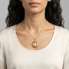 Woman wearing a Victorian Reflections Carnelian & Ivory Cameo Pendant Faux Pearl Necklace