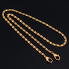 Gold tone Classy Link Face Mask Chain Holder on a black background