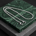 Silver tone Classy Link Face Mask Chain Holder resting on green marble