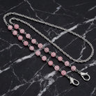 Pink Beaded Face Mask Chain Holder on a black marble surface