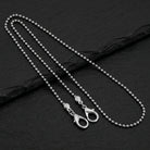 Stainless Steel 2.4 mm Ball Chain Mask Holder with a clasp on a black stone surface