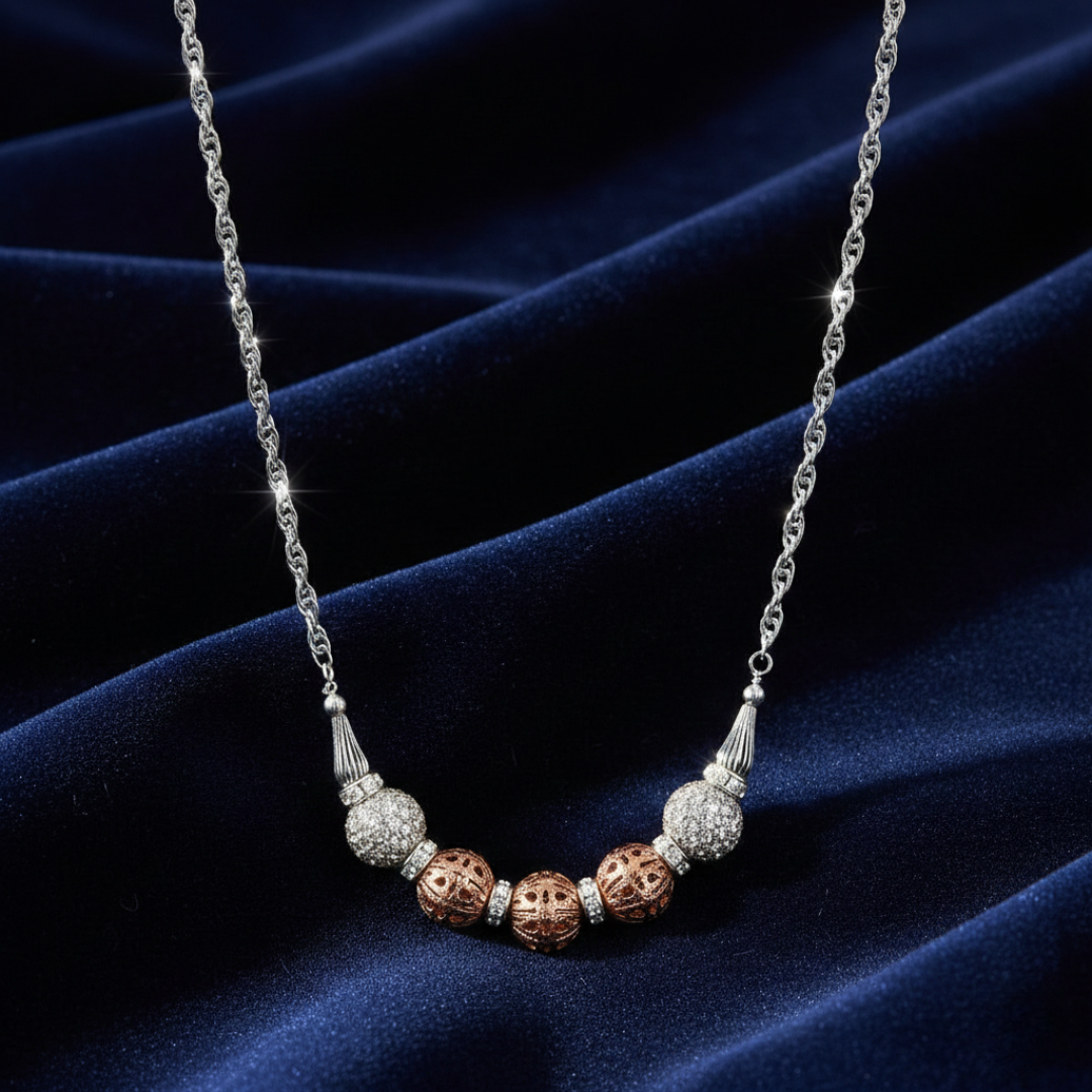 Necklace with decorative beads and crystals on a dark blue fabric background