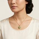 Woman wearing a Green and Gold Tone Artisan Heart Picture Locket Pink Rose Necklace