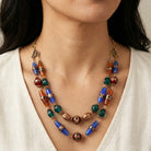 Colorful Bohemian beaded necklace worn by a person against a neutral background