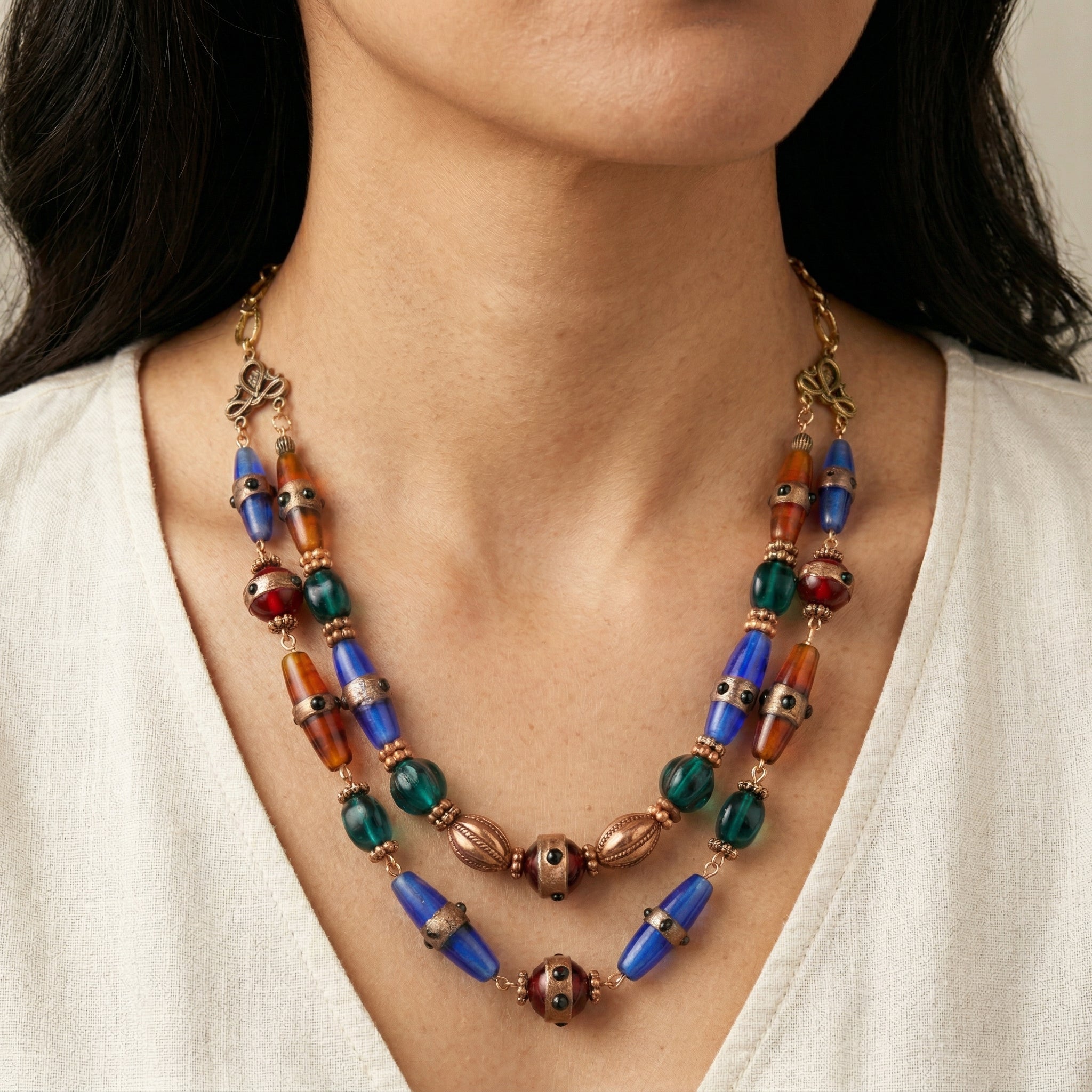 Colorful Bohemian beaded necklace worn by a person against a neutral background