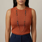 Woman in a dark orange top wearing a Bohemian Multi Color Strandage Necklace