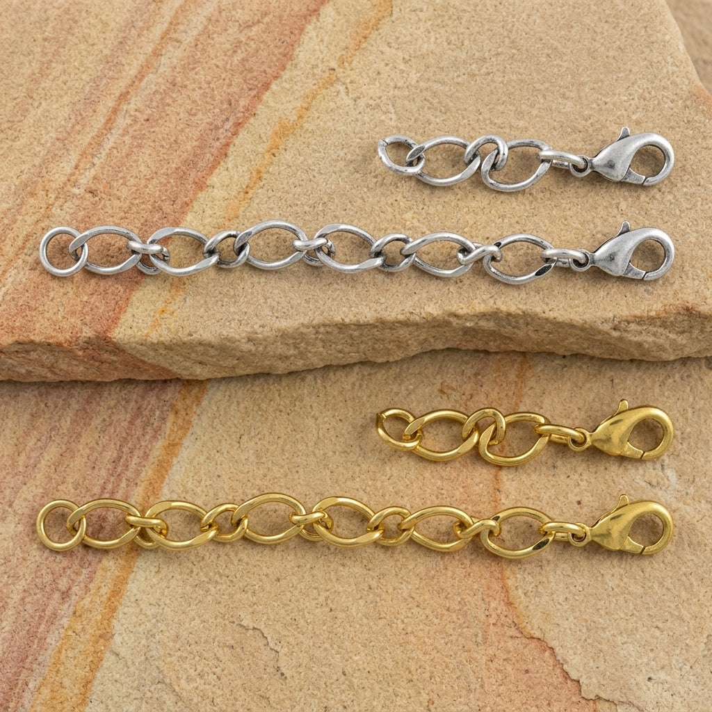Silver and gold chain extensions on a stone surface