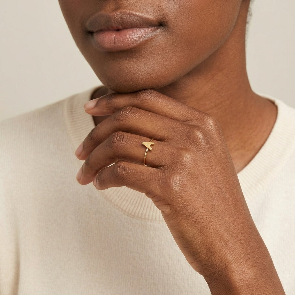 Woman posting her hand forward wearing a Gold Initial Ring with the letter "A" 