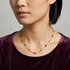 Woman wearing a purple velvet top and a Purple Beaded Chain Necklace