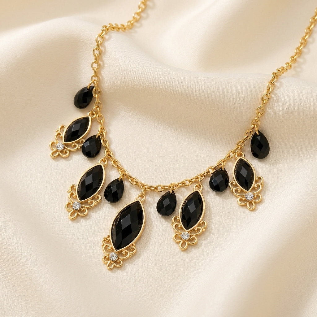 Black Teardrop Crystal Necklace on a beige fabric background