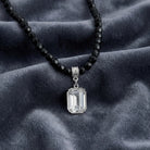 Genuine Octagon Austrian Crystal Black Glass Beaded Pendant Necklace on a textured gray fabric surface