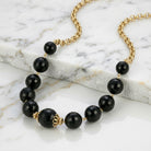 Round Square Cut Black Beaded Necklace on white marble surface