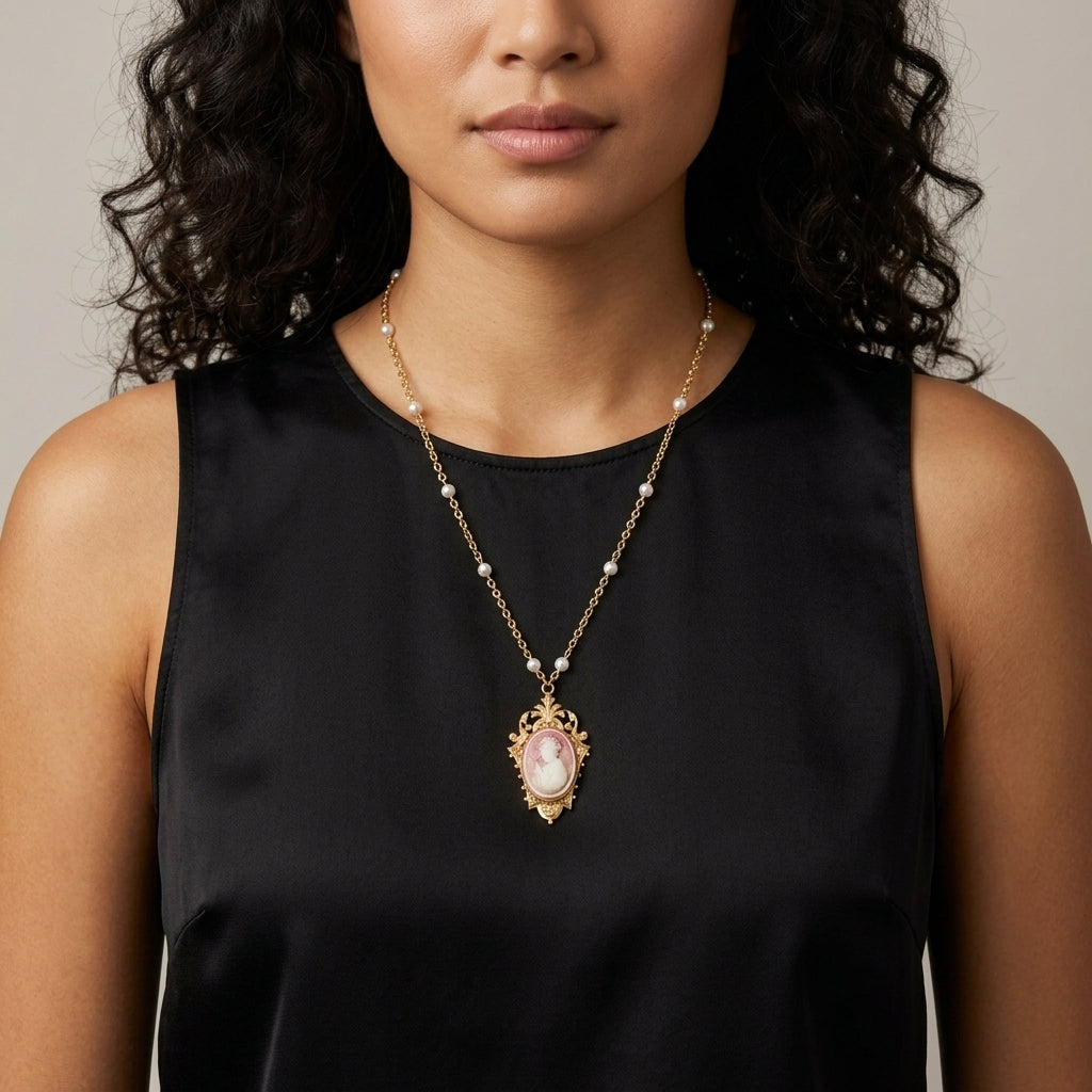 Woman wearing a black sleeveless top with a Victorian Reflections Carnelian & Ivory Cameo Faux Pearl Accent Necklace