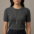 Woman in a dark outfit wearing a Lesser Celandine Flower Whistle Pendant Necklace