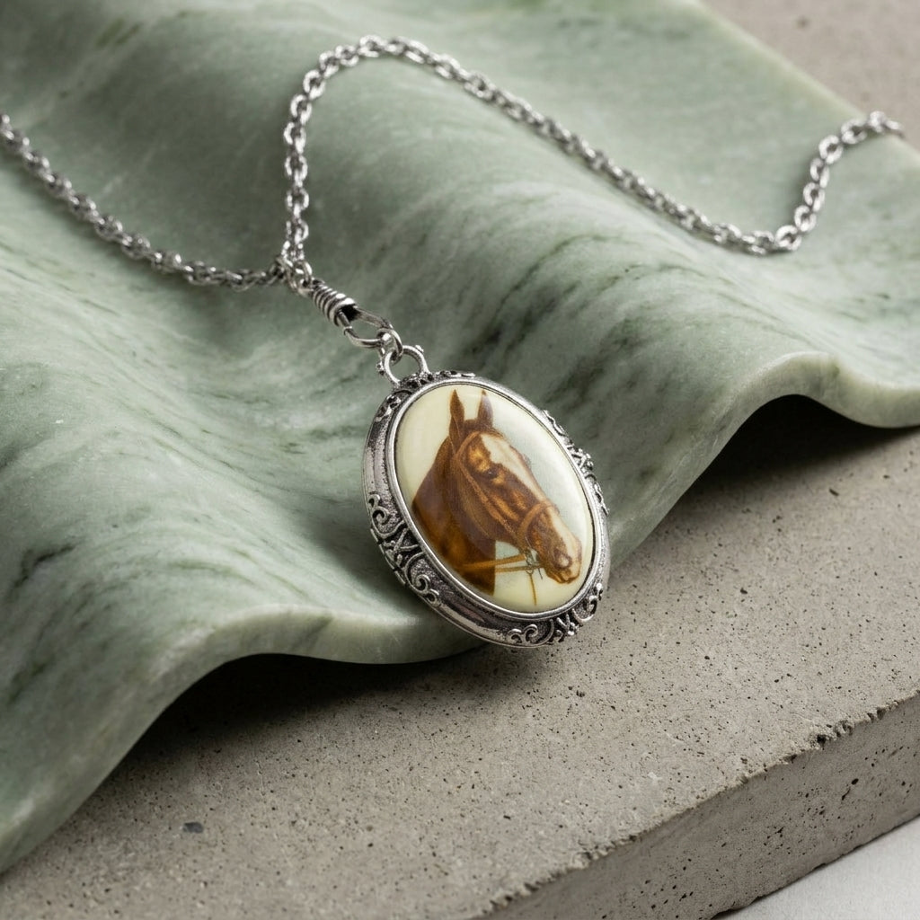 Rayo Caballo Oval Stone Swivel Pendant Necklace on a green stone surface.