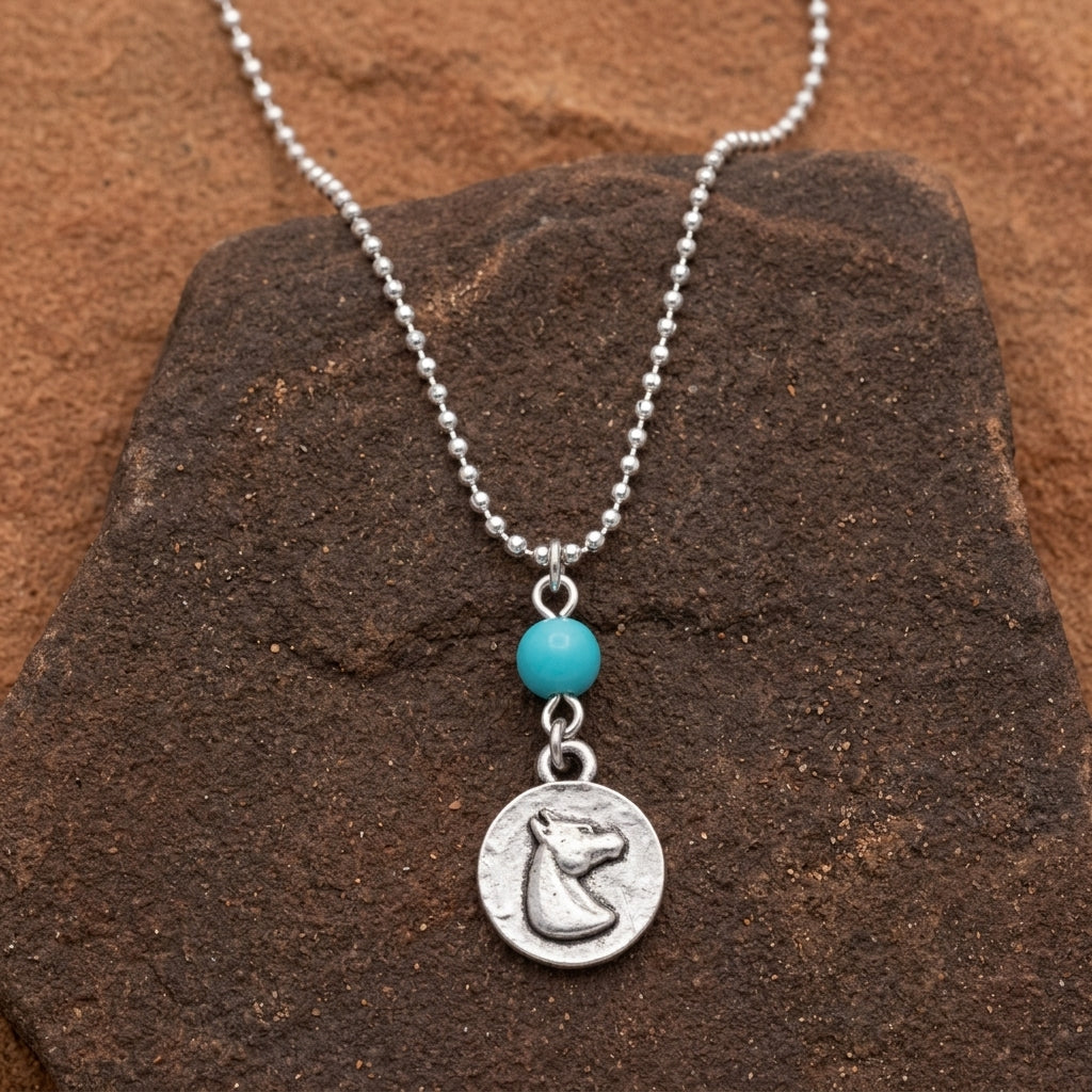 Southwest Turquoise Bead Horse Head Pendant Necklace on dark stone surface