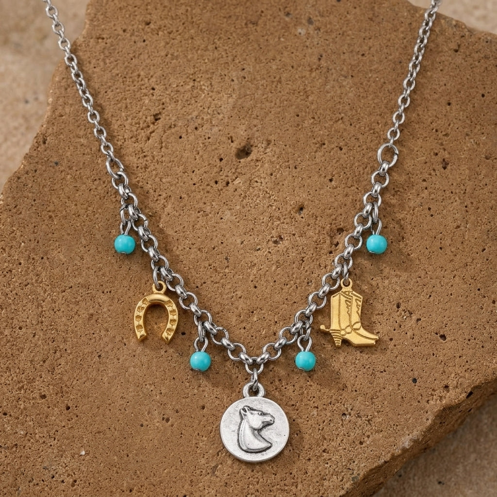 Necklace with charms including a horse head, horseshoe, and cowboy boot on a brown stone background