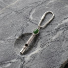 Jade Gemstone Filigree Whistle Carabiner Key Chain on a marble surface