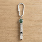 Jade Gemstone Filigree Whistle Carabiner Key Chain on a wooden surface