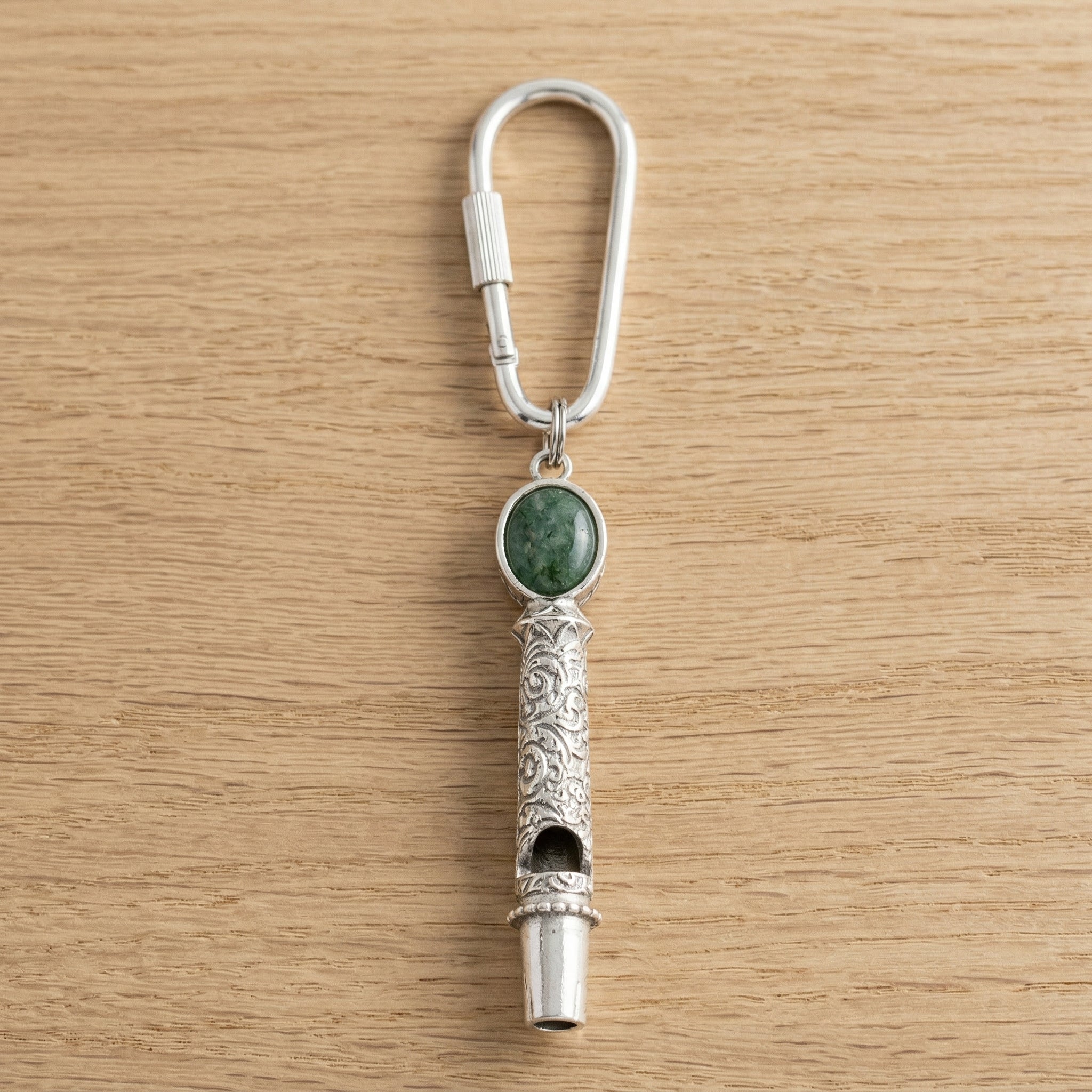 Jade Gemstone Filigree Whistle Carabiner Key Chain on a wooden surface