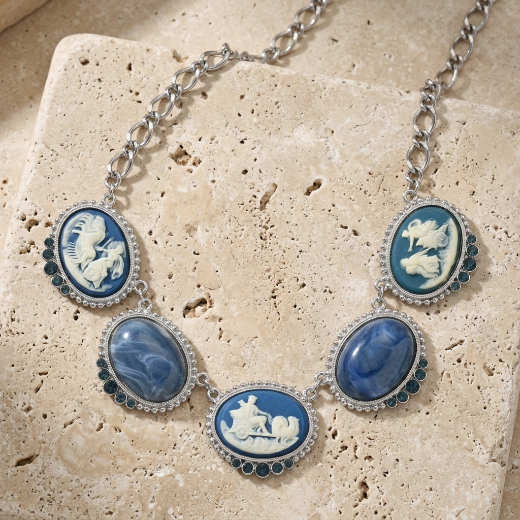 Necklace with blue and white cameo pendants on a textured stone surface