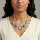 Woman wearing a Roman Chariot Races Cameo Blue Stone Chain Necklace