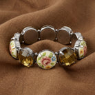 Olivine & Multicolored Floral Stone Stretch Bracelet on a brown fabric background