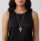 Woman wearing a black sleeveless top with Montana Blue Crystal Channel Cross Pendant Necklace
