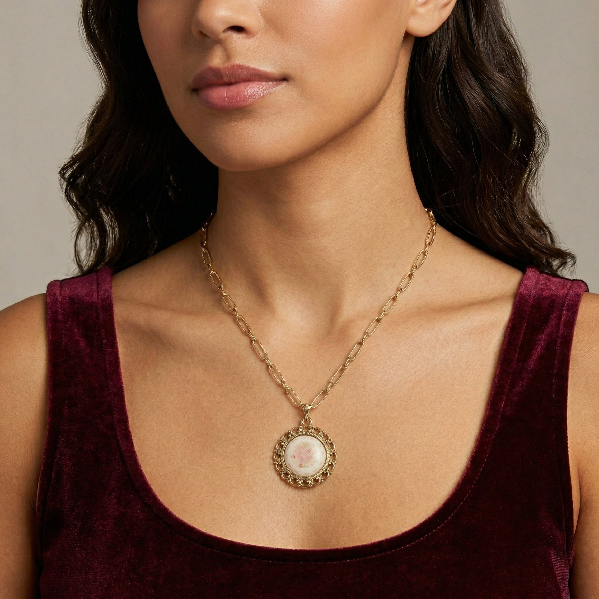 Woman wearing a gold tone Stitch Pattern Pink Rose Pendant Necklace