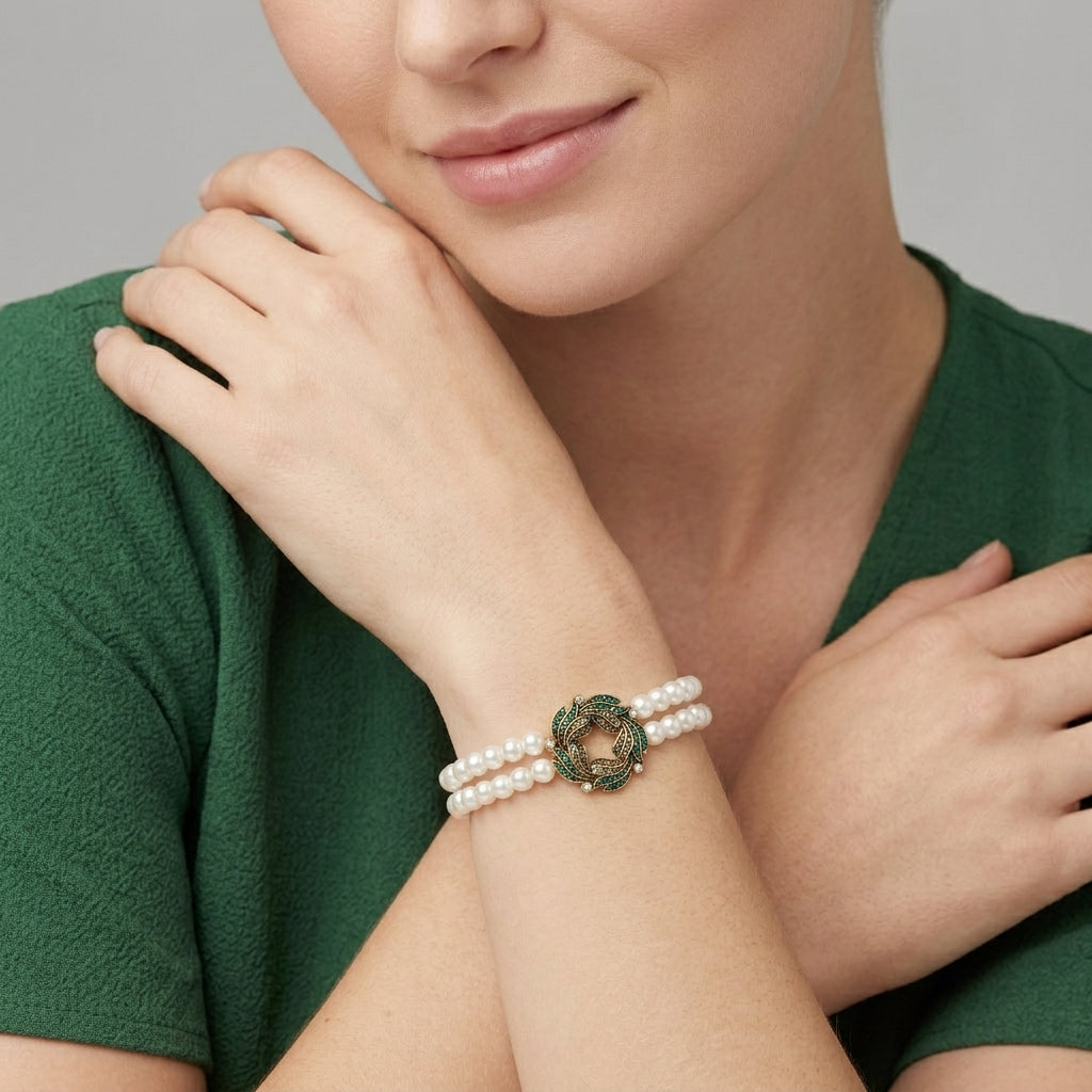 Woman wearing a pearl bracelet with a green floral wreath design against her green dress