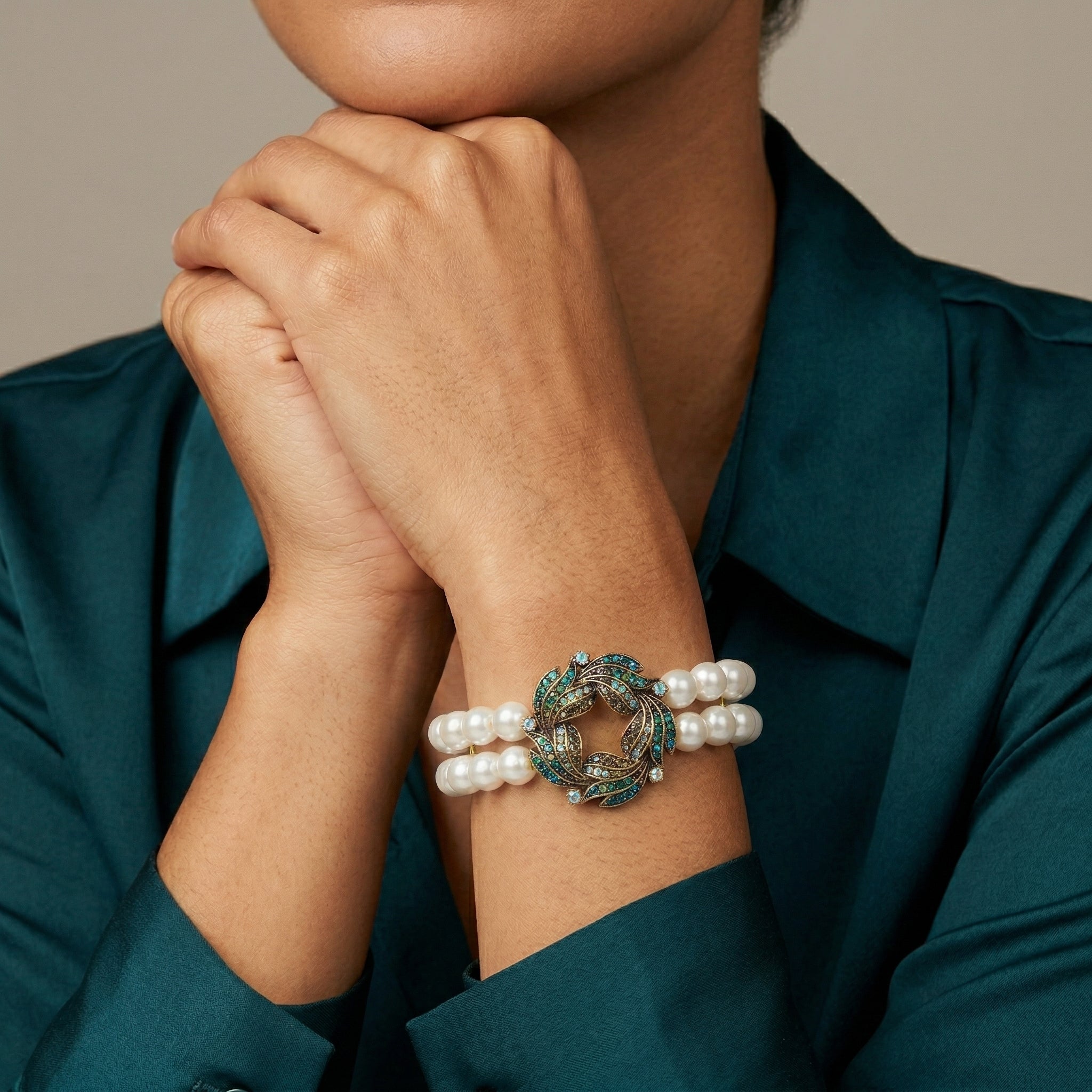 Woman wearing a Peacock Plumage Blue Iridescent AB White Faux Pearl Wreath Bracelet