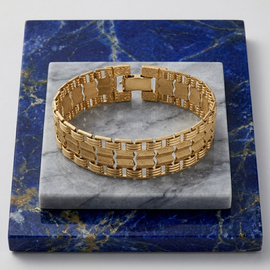 Classic Swag Chain Bracelet on a marble and blue stone surface