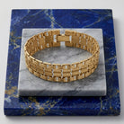 Classic Swag Chain Bracelet on a marble and blue stone surface