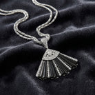 Deco Fantasy Black Stone & Crystal Fan Pendant Necklace on a dark fabric background