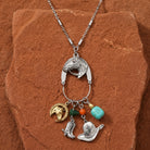Equestrian Charms Horse Head Pendant Necklace on a textured brown stone surface