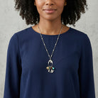 Woman wearing a navy blue top and Equestrian Charms Horse Head Pendant Necklace