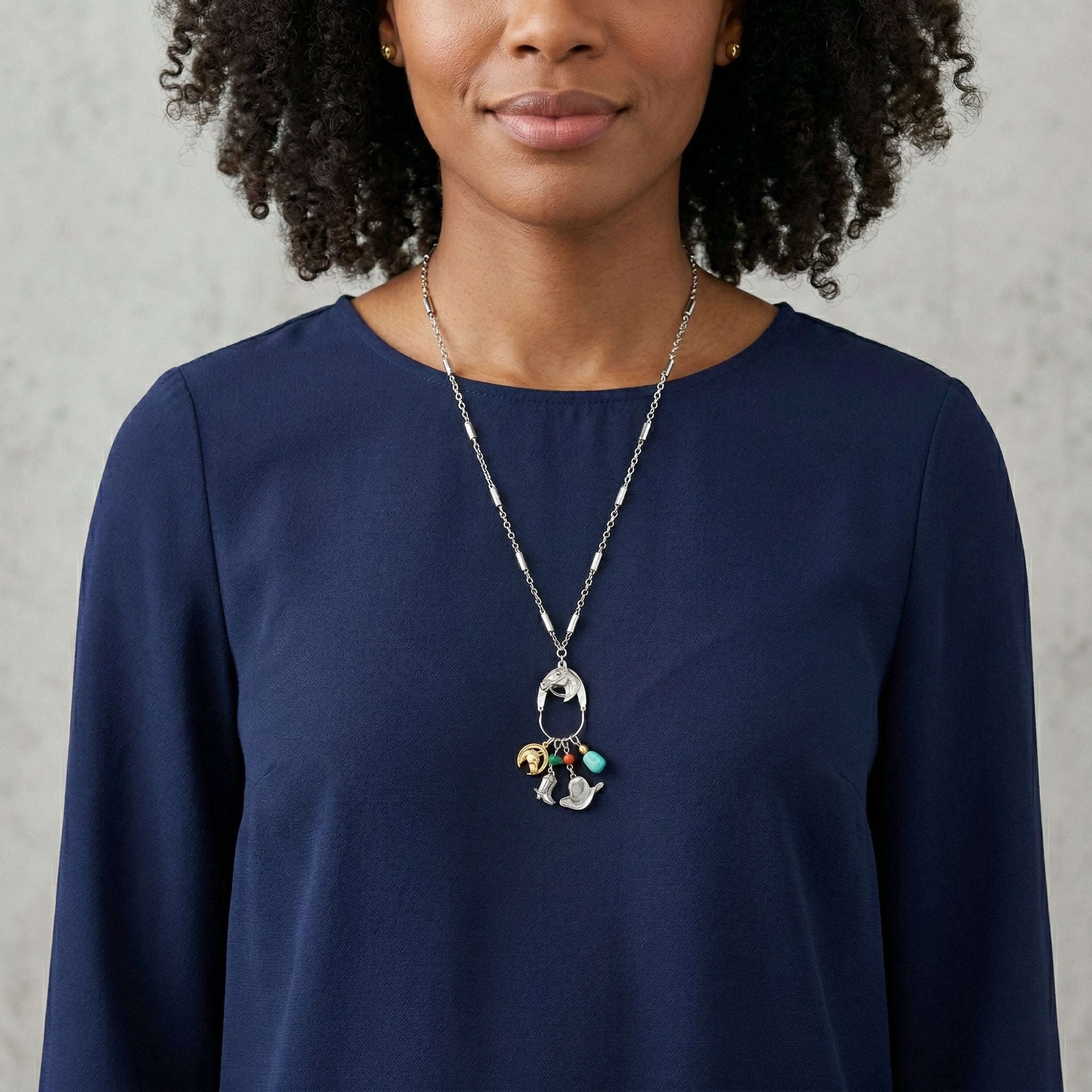 Woman wearing a navy blue top and Equestrian Charms Horse Head Pendant Necklace