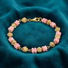 Pink Vintage Flower Power Beaded Bracelet on a teal fabric background