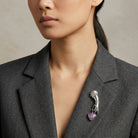 Woman wearing a gray blazer with Belle Epoch Ladies Hand Light Purple Bead Heart Drop Pin