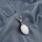 Gemstone Bead Pendant Necklace on a gray fabric background