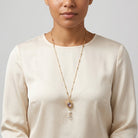 Woman wearing a White Crystal Opal Stone 3 Sided Spinner Drop Necklace