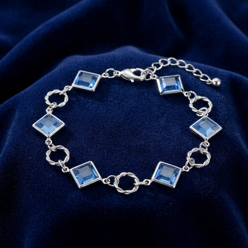 Silver tone Sapphire Blue Austrian Crystal Square Link Bracelet on a dark blue fabric background