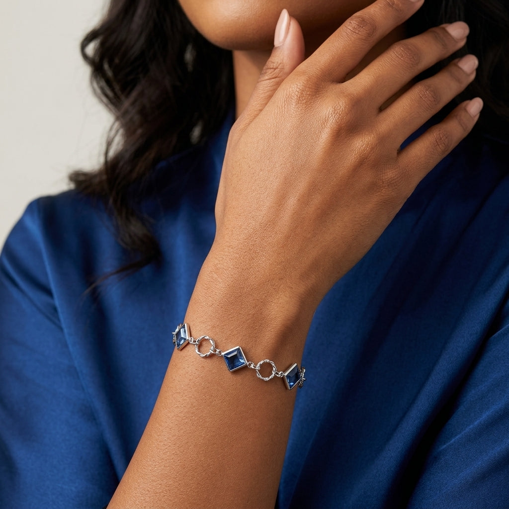Sapphire Blue Austrian Crystal Square Link Bracelet on the wrist of a woman wearing a blue dress