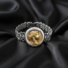Silver bracelet with a gold coin featuring a Grecian woman cameo on black satin fabric