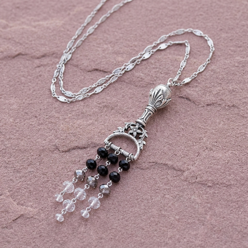 Multi Black Crystal Chandelier Ornamental Pendant on a pink stone surface