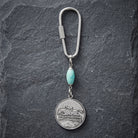 Turquoise Gemstone  Bead Horseback Rider Carabiner Key Chain on dark stone surface