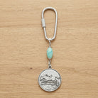 Turquoise Gemstone  Bead Horseback Rider Carabiner Key Chain on wooden surface