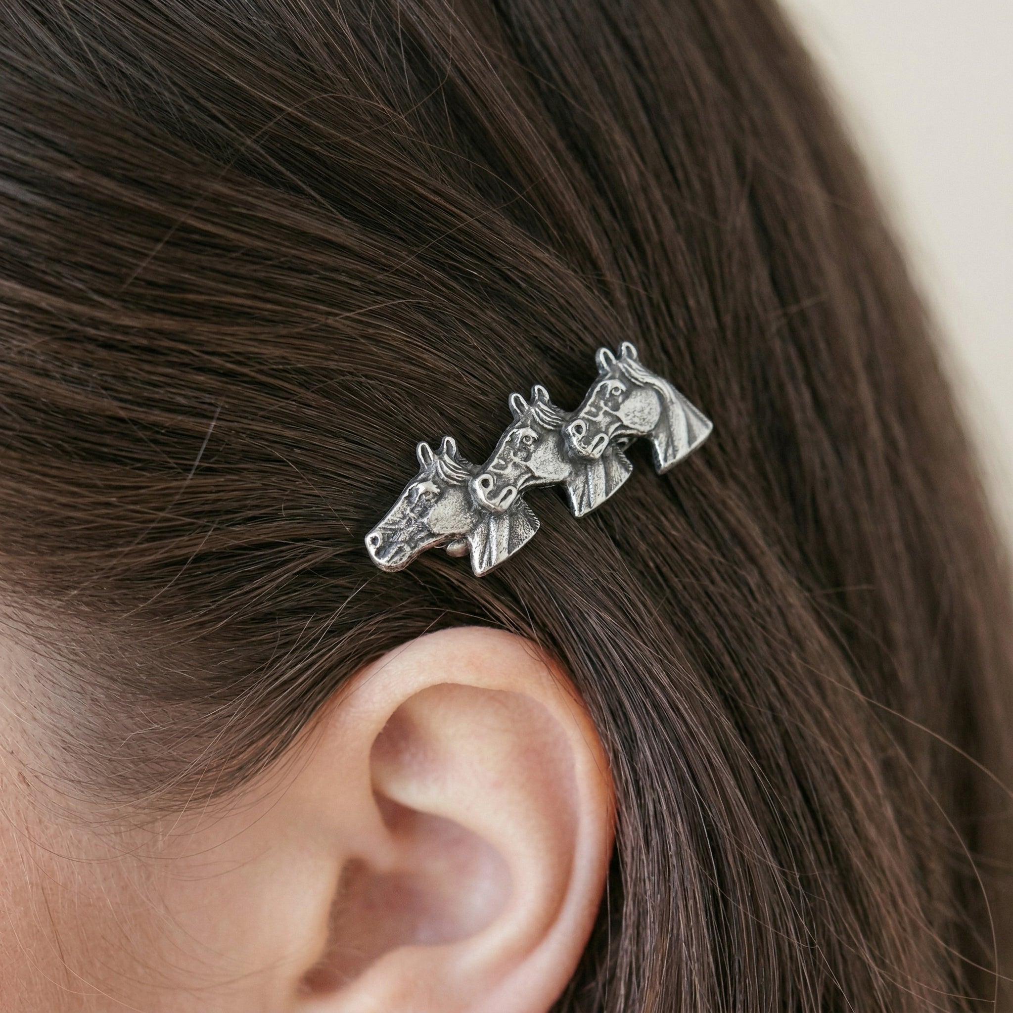 Woman wearing a Small Antiqued Horse Herd Hair Barrette