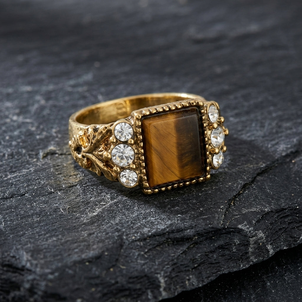 Tigers Eye Gemstone Crystal Accent Ring
on a dark stone surface